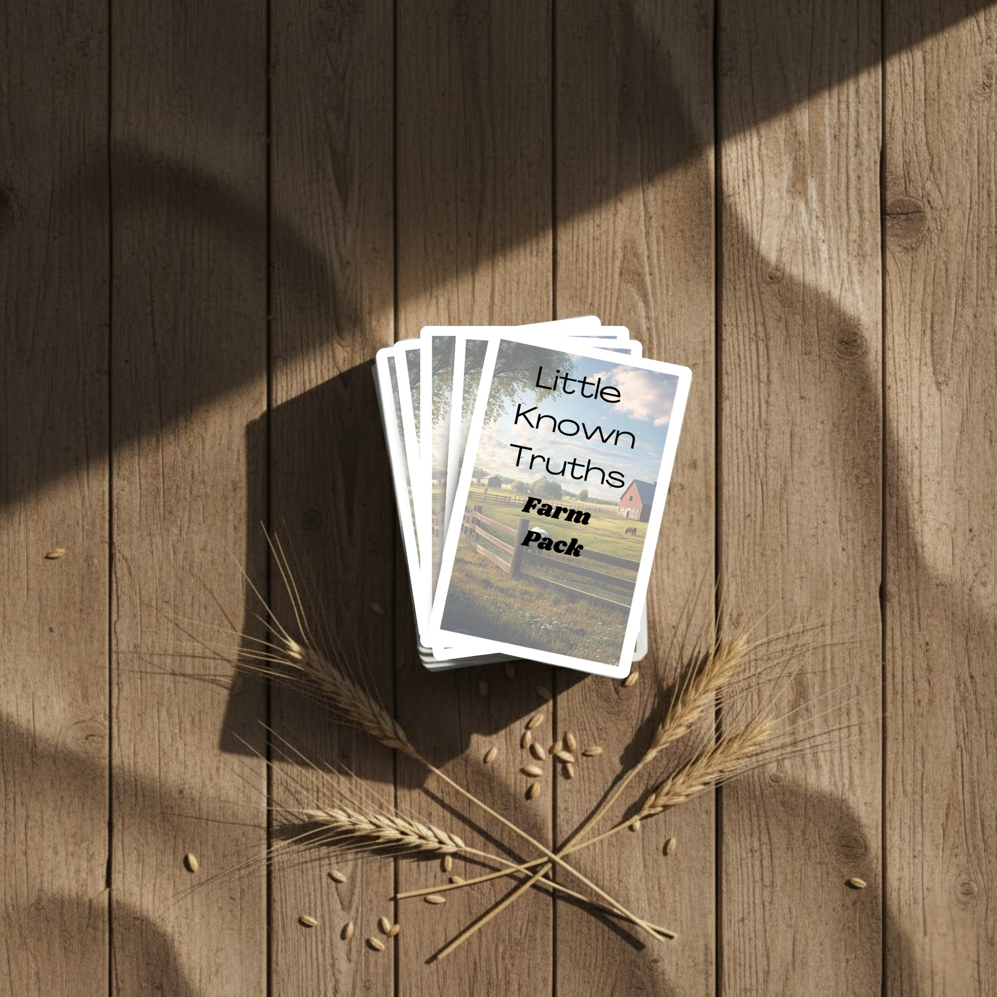Card pack titled 'Little Known Truths Farm Pack' on a wooden surface with wheat stalks.