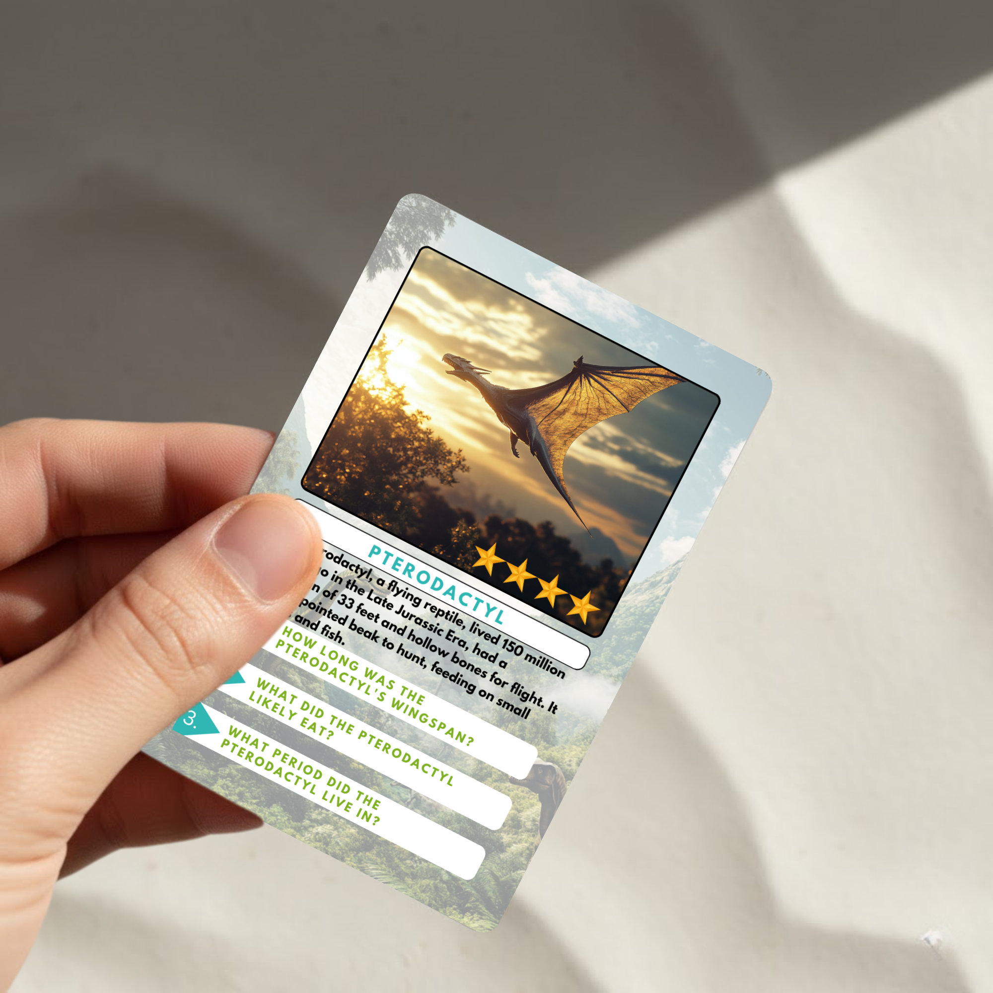 Hand holding a trading card featuring a pterodactyl dinosaur with a sunset background