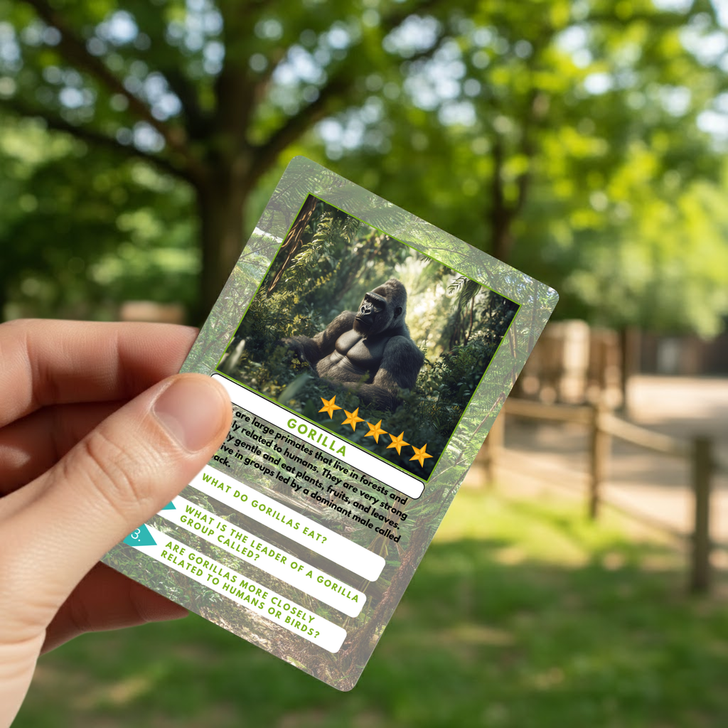 Card with a gorilla and zoo fun facts  held by a hand in front of a natural background